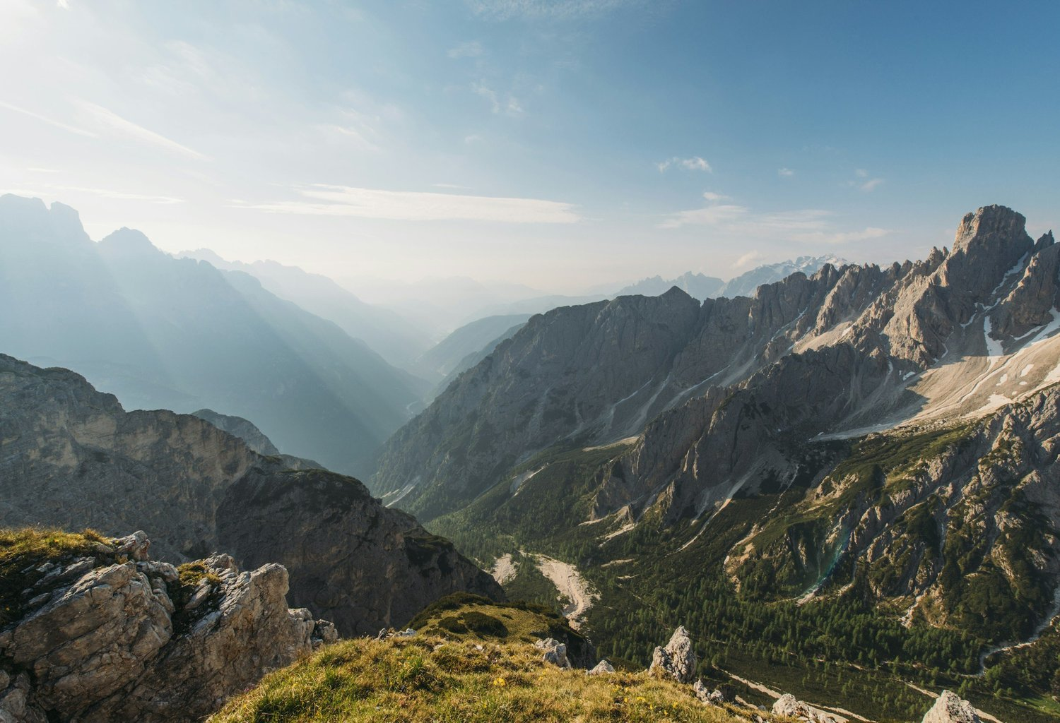 A mountain valley and a trail opening onto a wider view